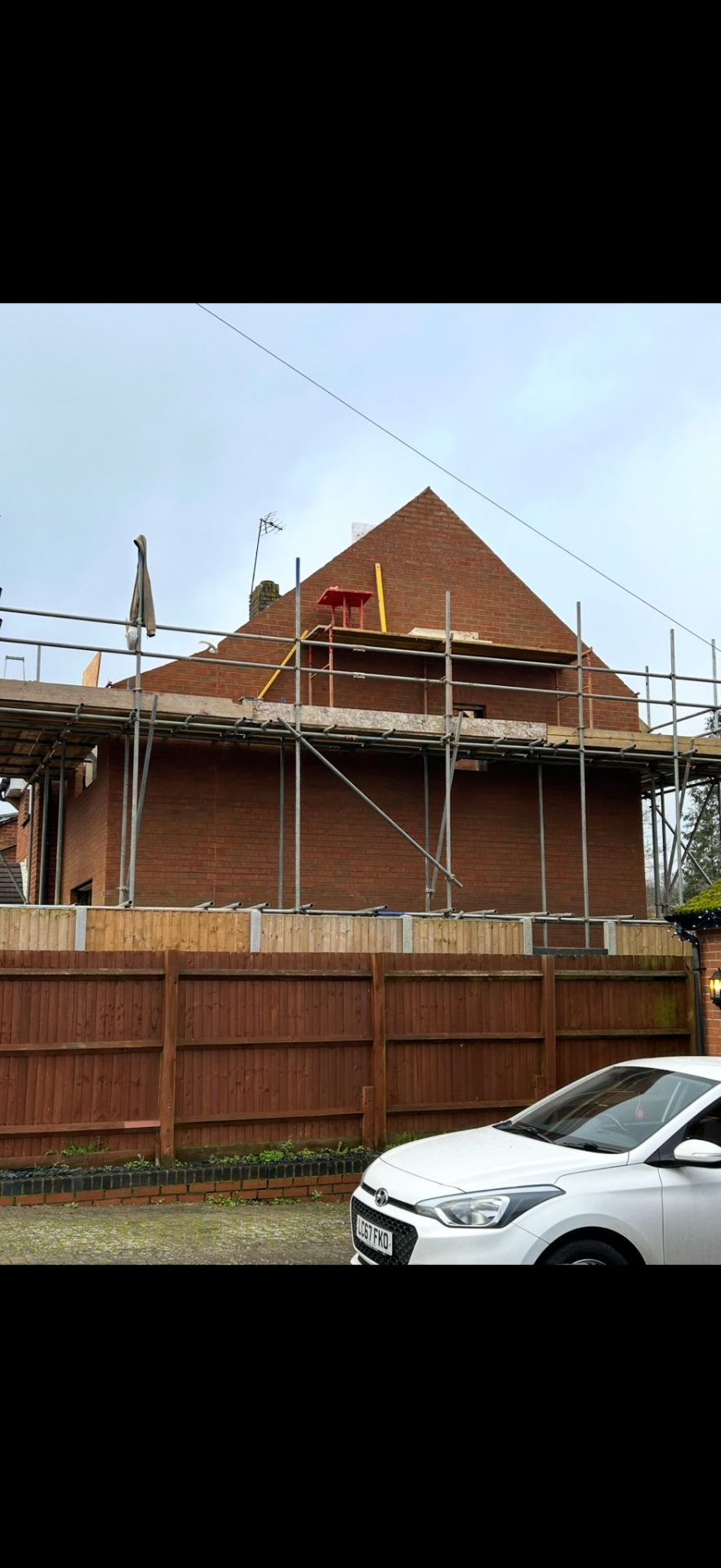 Two-storey home extension with scaffolding by Burton Builds