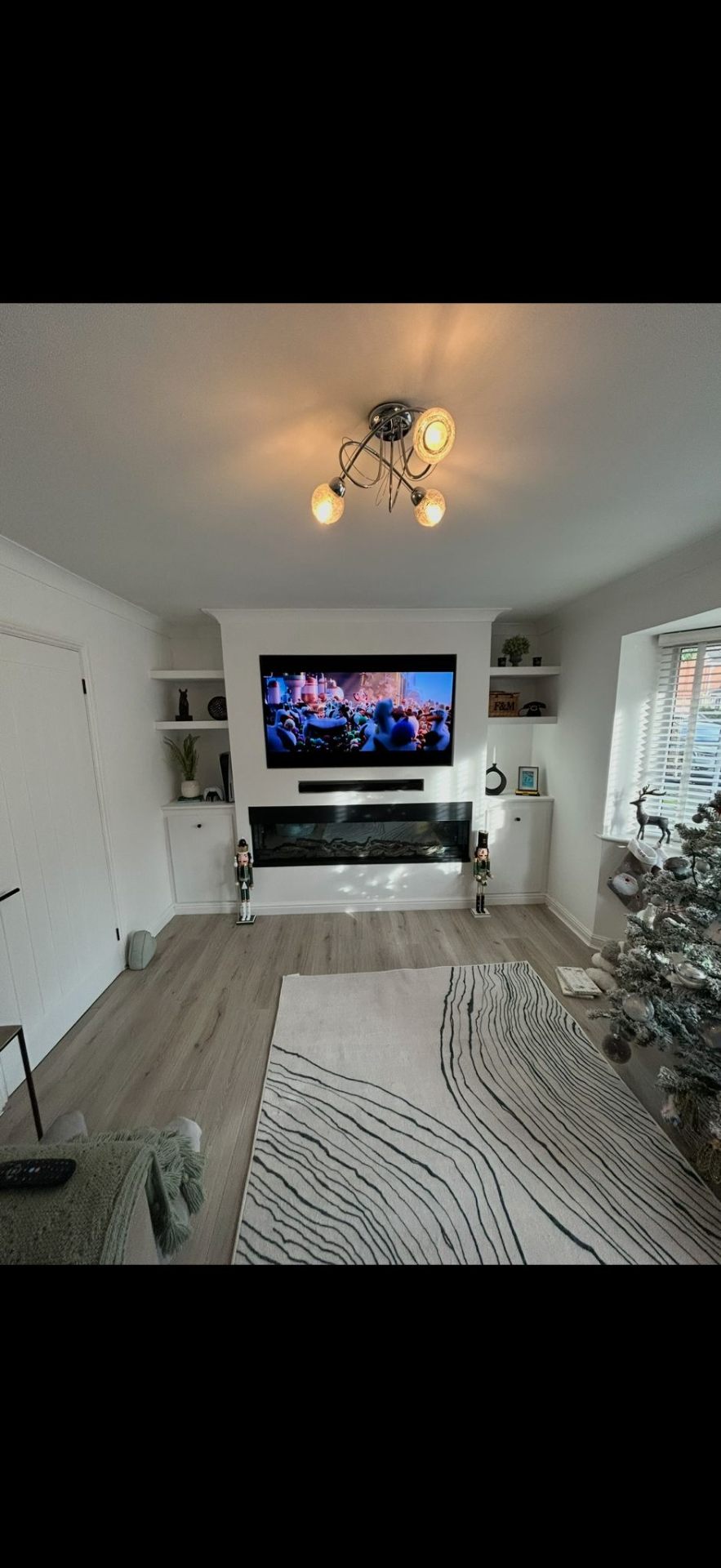 Custom media wall with TV and electric fireplace by Burton Builds