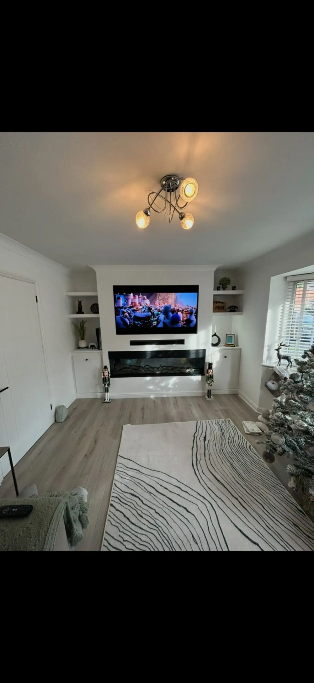 Custom media wall with TV and electric fireplace by Burton Builds