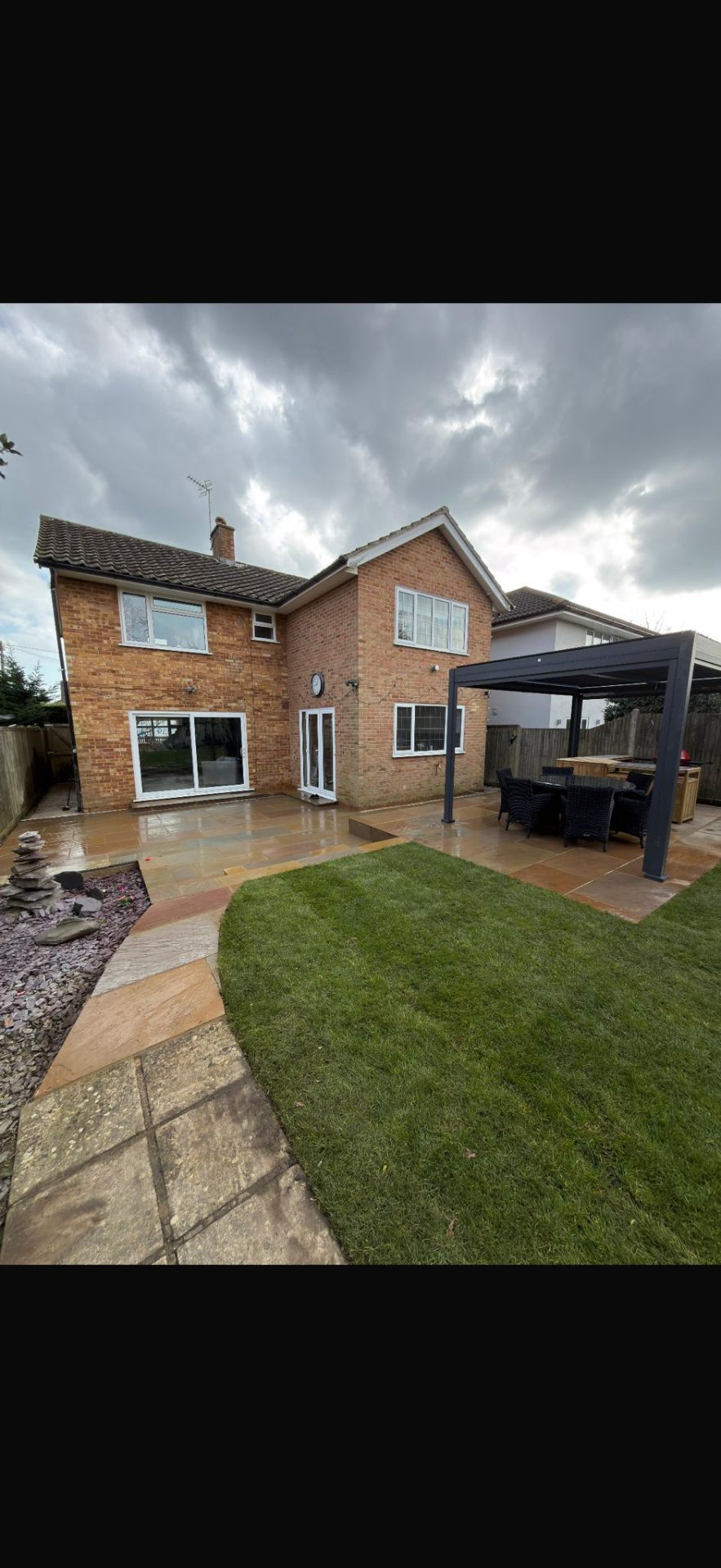 Home extension with natural stone patio and drainage by Burton Builds